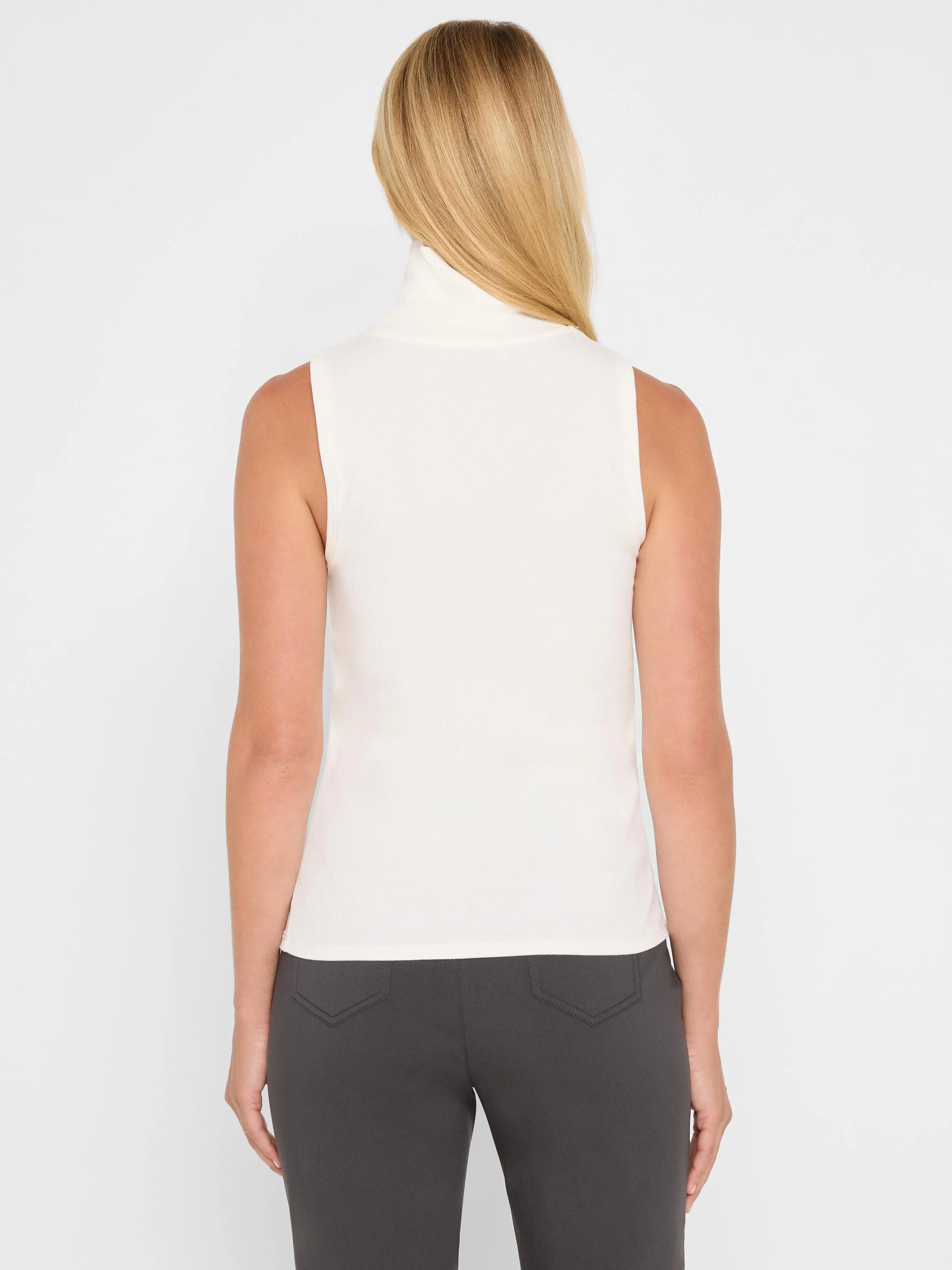 Cream ribbed turtleneck tank top, sleeveless and fitted.
