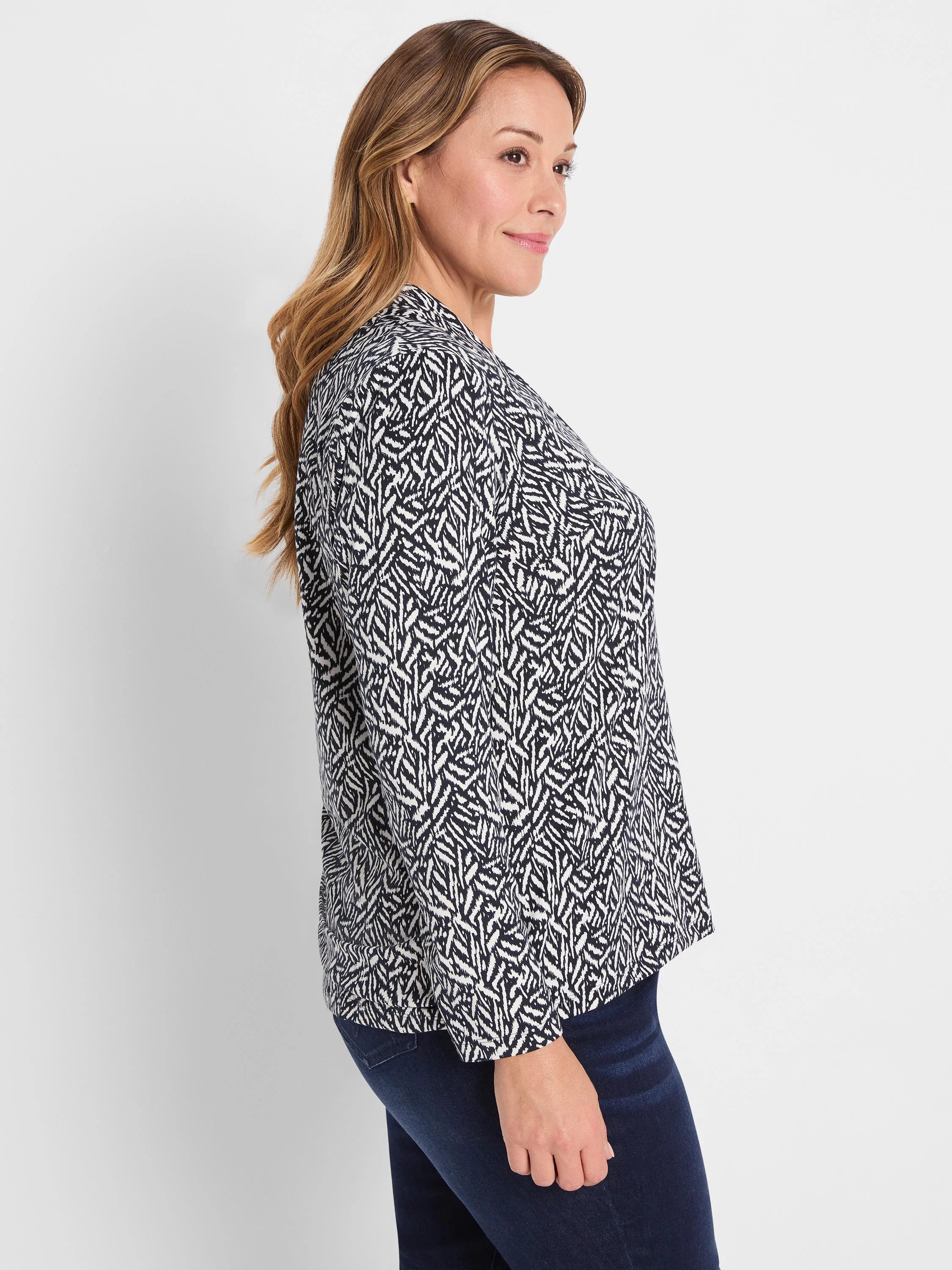 Navy and off-white knit top with a dense, abstract geometric pattern of irregular shapes.