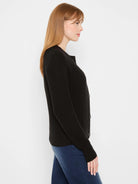 Black waffle tuck knit cardigan with dark front buttons.