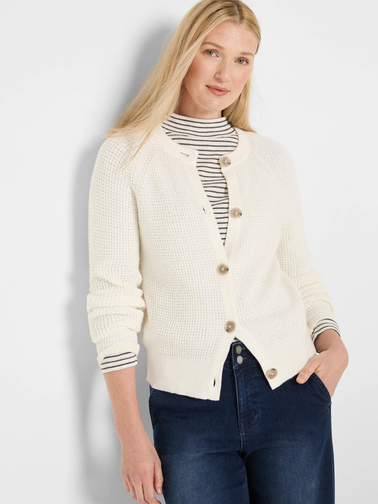 Cream waffle knit cardigan with round, light brown buttons & a collarless neckline.