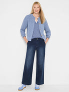 Light blue waffle-knit cardigan with a round neck, long sleeves, and light-colored buttons.