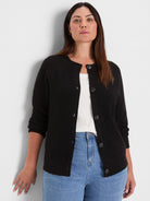 Black waffle tuck knit cardigan with a round neck and dark button-front.