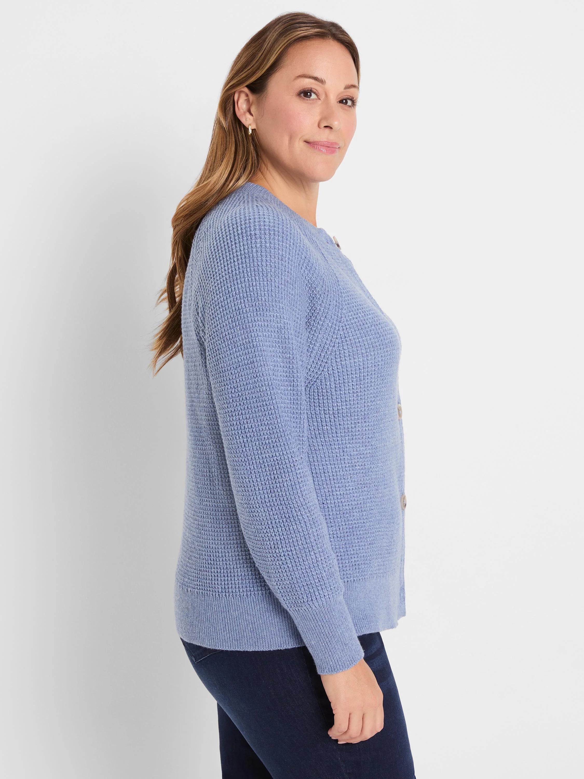 Periwinkle blue waffle knit cardigan with light buttons, worn by a woman with dark jeans.
