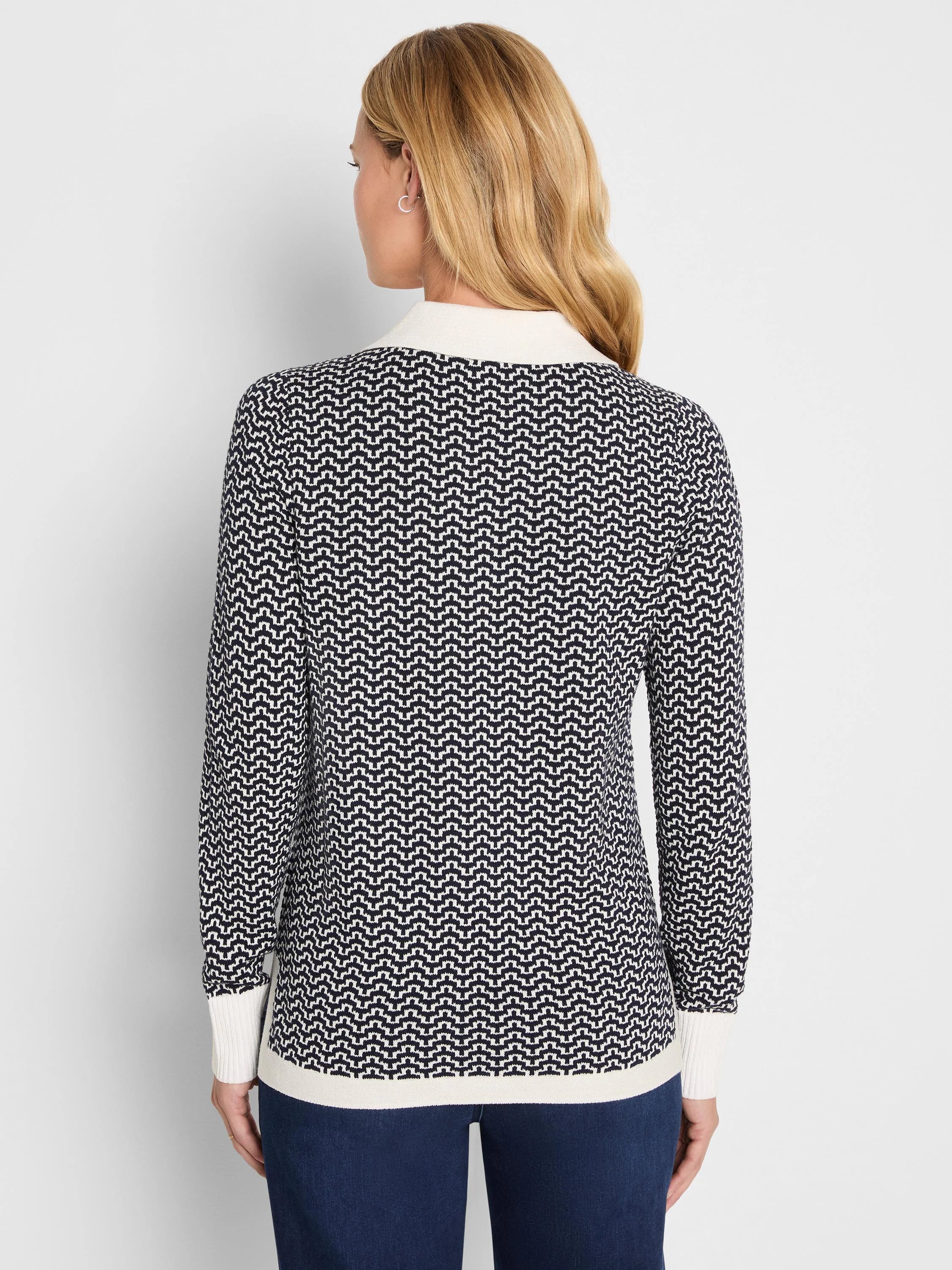 Jacquard sweater in dark blue and cream zigzag pattern. Cream collar, cuffs, and hem.