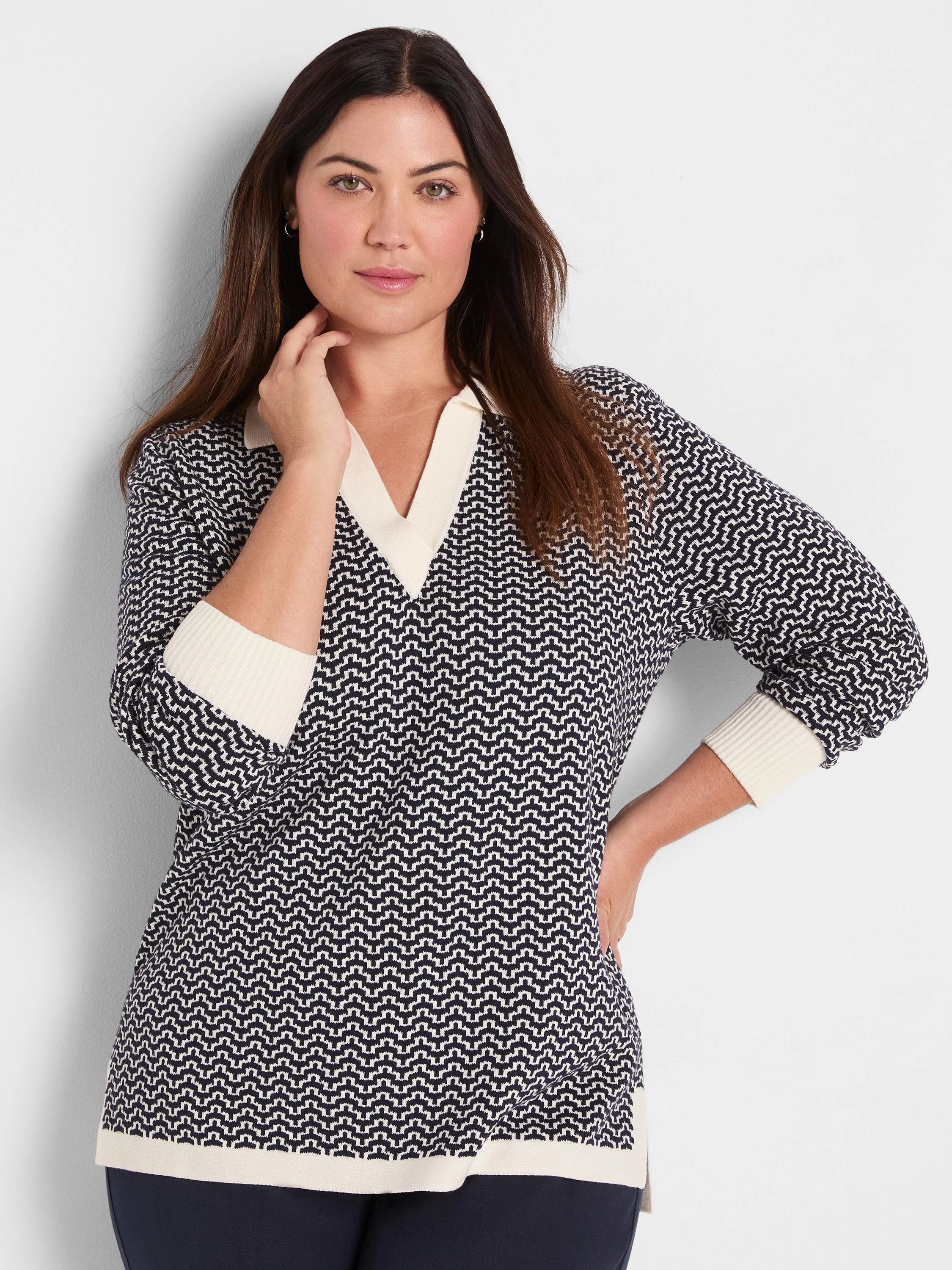 Two-tone navy and cream sweater with a zig-zag pattern. Features a V-neck, solid cream collar, cuffs, and hem.