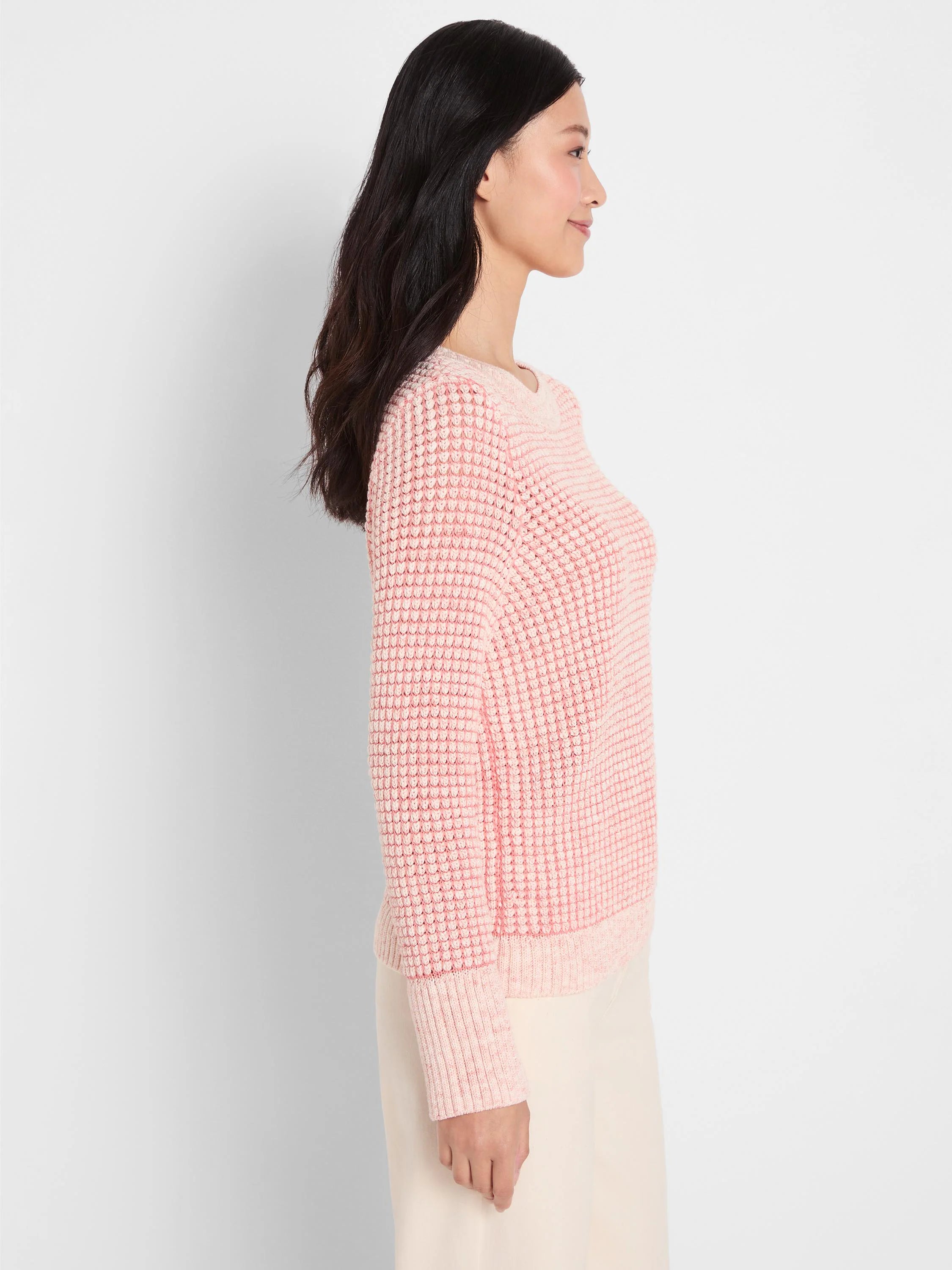 Textured pink knit sweater with subtle flecks of color, crew neck, and ribbed cuffs.