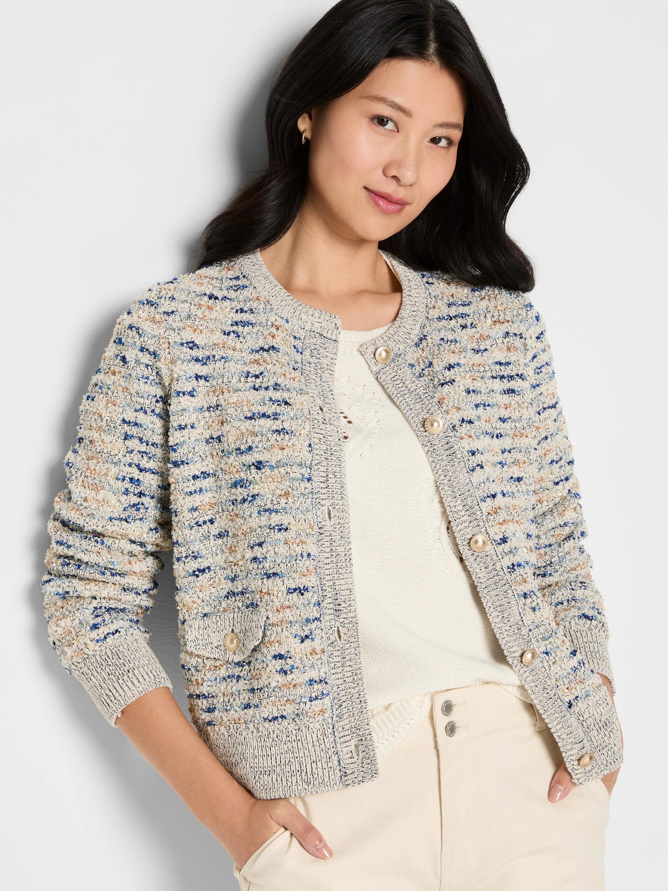 Cream bouclé knit jacket with blue & tan yarns. Collarless, button-front, two buttoned patch pockets.