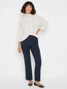 Light grey cable knit turtleneck sweater with openwork details and subtle sparkle.