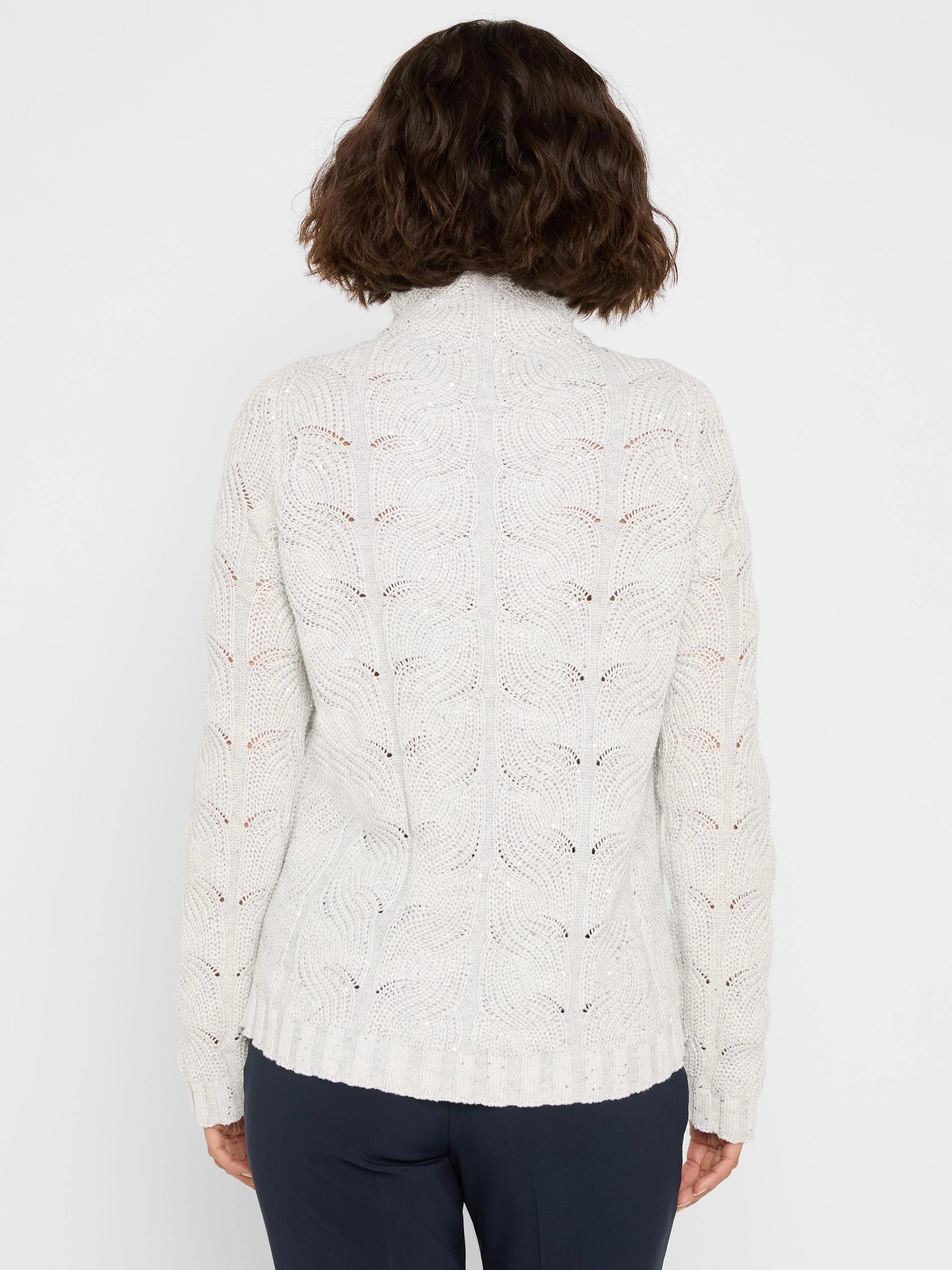 Back view of a light gray cable knit sweater with all-over sparkle, high neck, and ribbed hem.