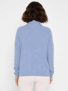 Periwinkle blue waffle knit sweater with a high neck and long sleeves, shown from the back.
