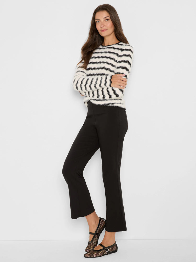 Black and white sweater with wavy, textured stripes.