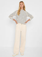 Grey knit mock neck sweater with cream diamond patterns on the body and cream stripes on the sleeves.