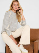 Light gray sweater with cream diamond cable knit patterns.