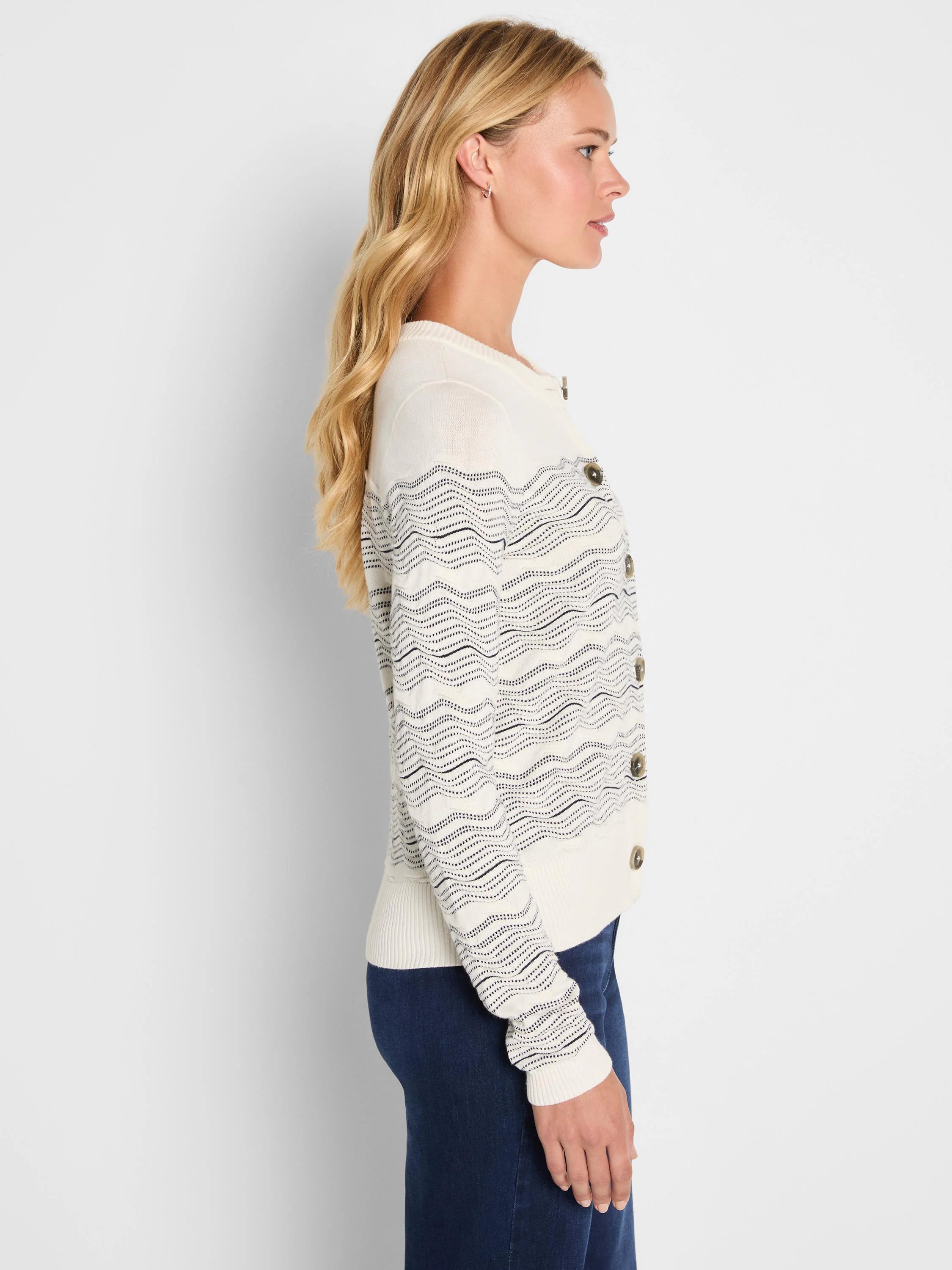 Ivory cardigan with black wavy zig-zag pattern and round brown buttons.
