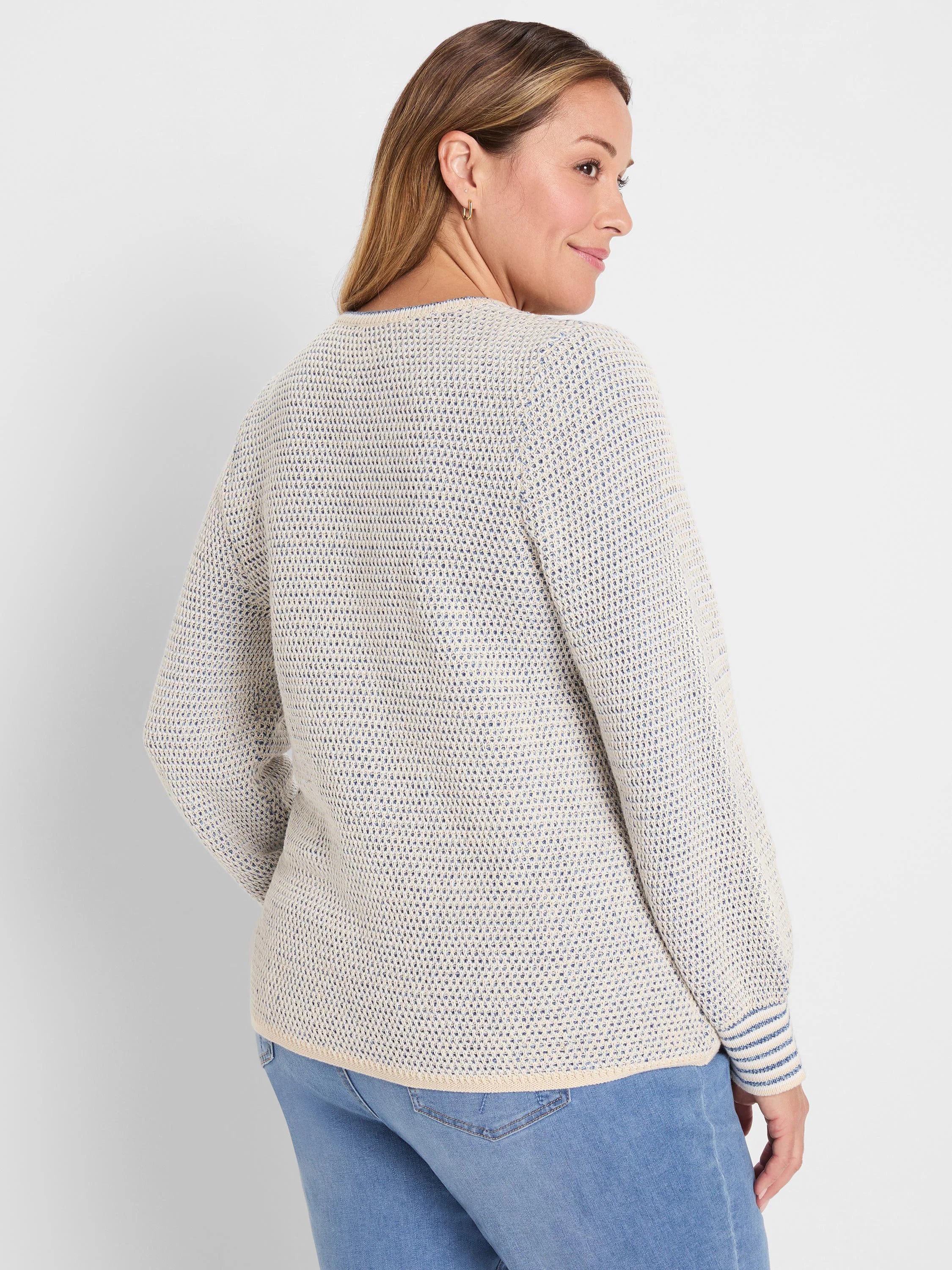 Cream and blue textured open knit sweater. Long-sleeved with striped cuffs and a ribbed hem.