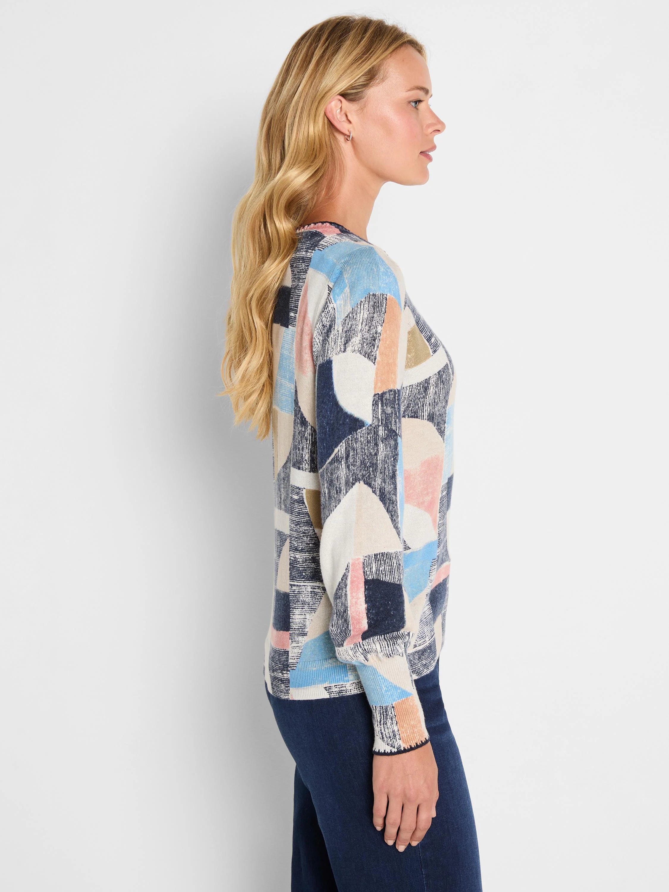 Sweater with abstract geometric shapes in navy, light blue, cream, pink, and peach, some textured.