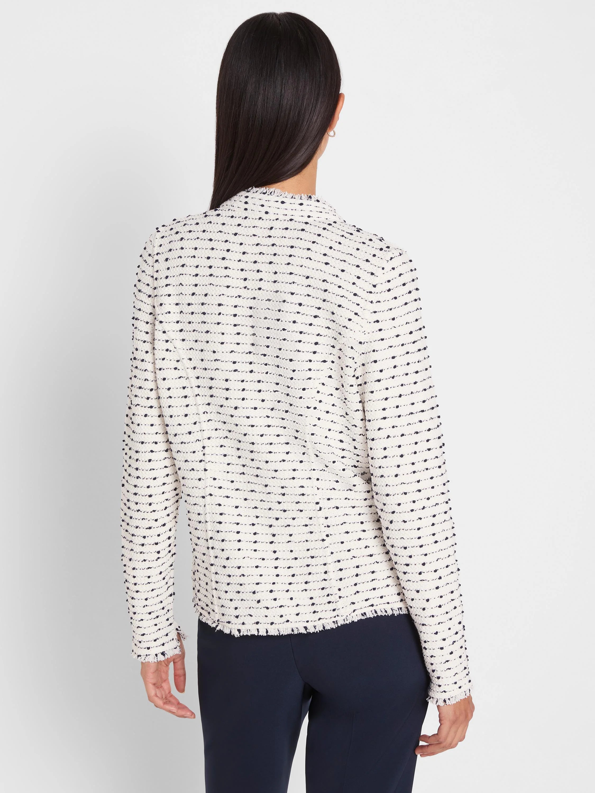 Off-white nep weave jacket with dark nubs. Features fringed hem and cuffs. Back view.