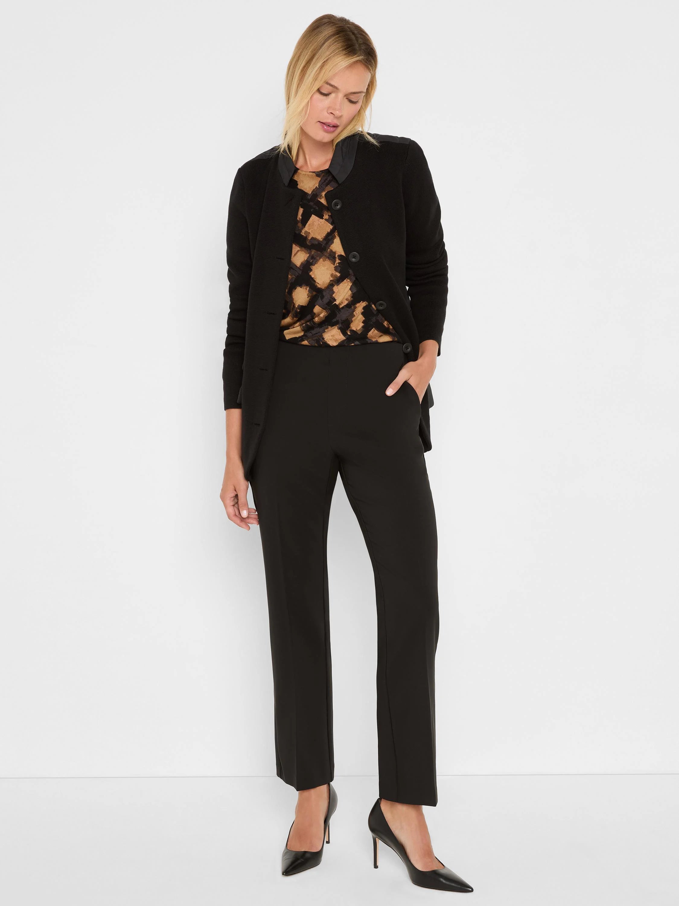 Black knit blazer with contrasting smooth black shoulder panels, a collarless neckline, and three front buttons.