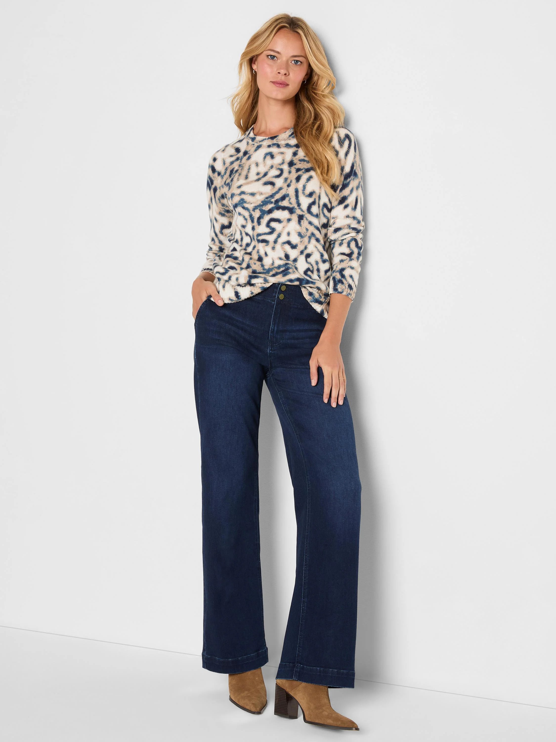 Cream sweater with abstract dark blue and tan blurry leaf pattern. Long sleeves, crew neck.