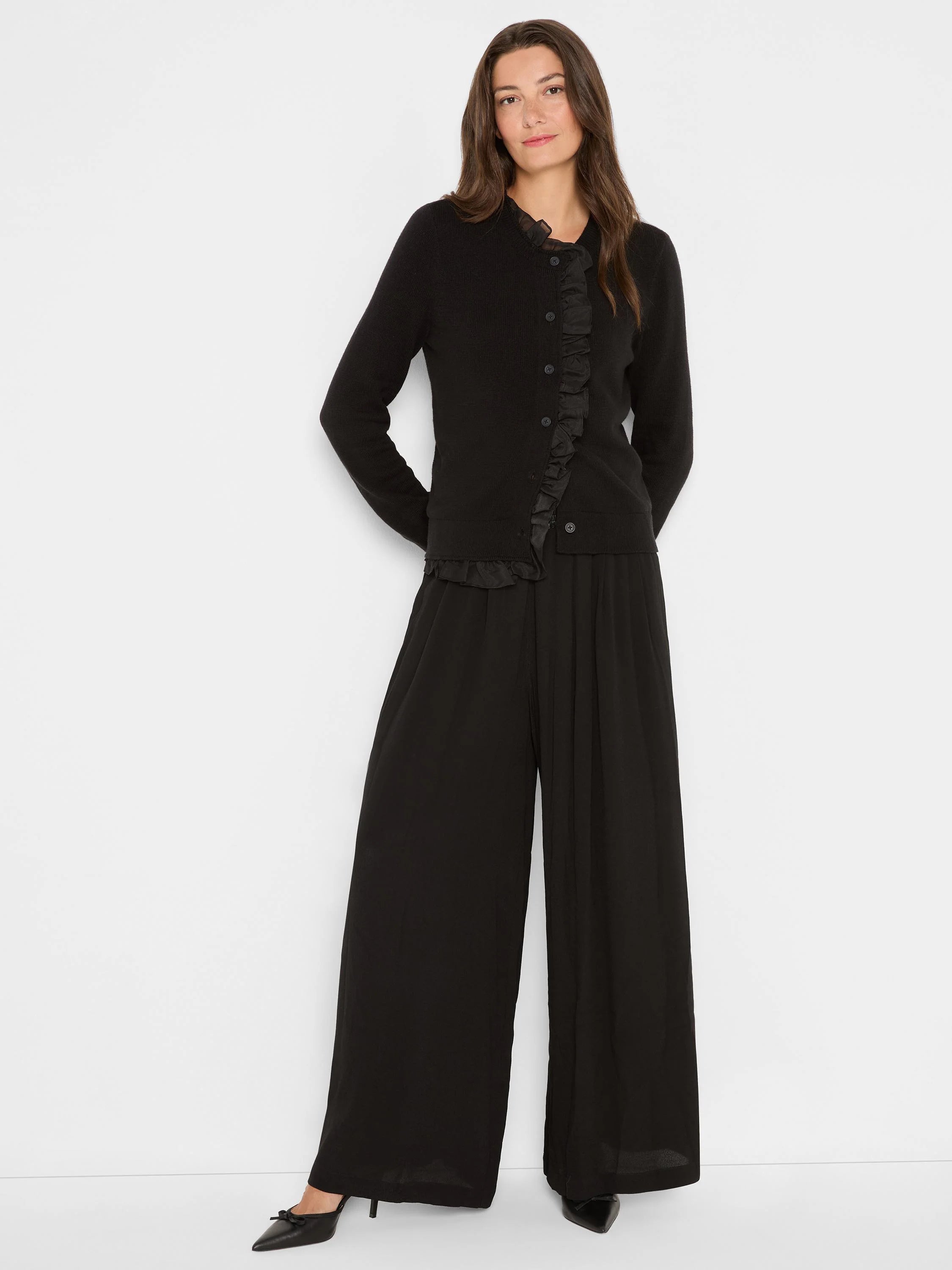 Black button-front cardigan with ruffles along the placket and hem.