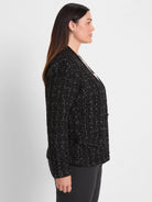 Black knit jacket featuring subtle metallic silver threads woven into a grid-like pattern.