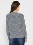 Back view of a shaker stitch sweater, made from speckled navy and white yarn, showcasing its chunky knit.