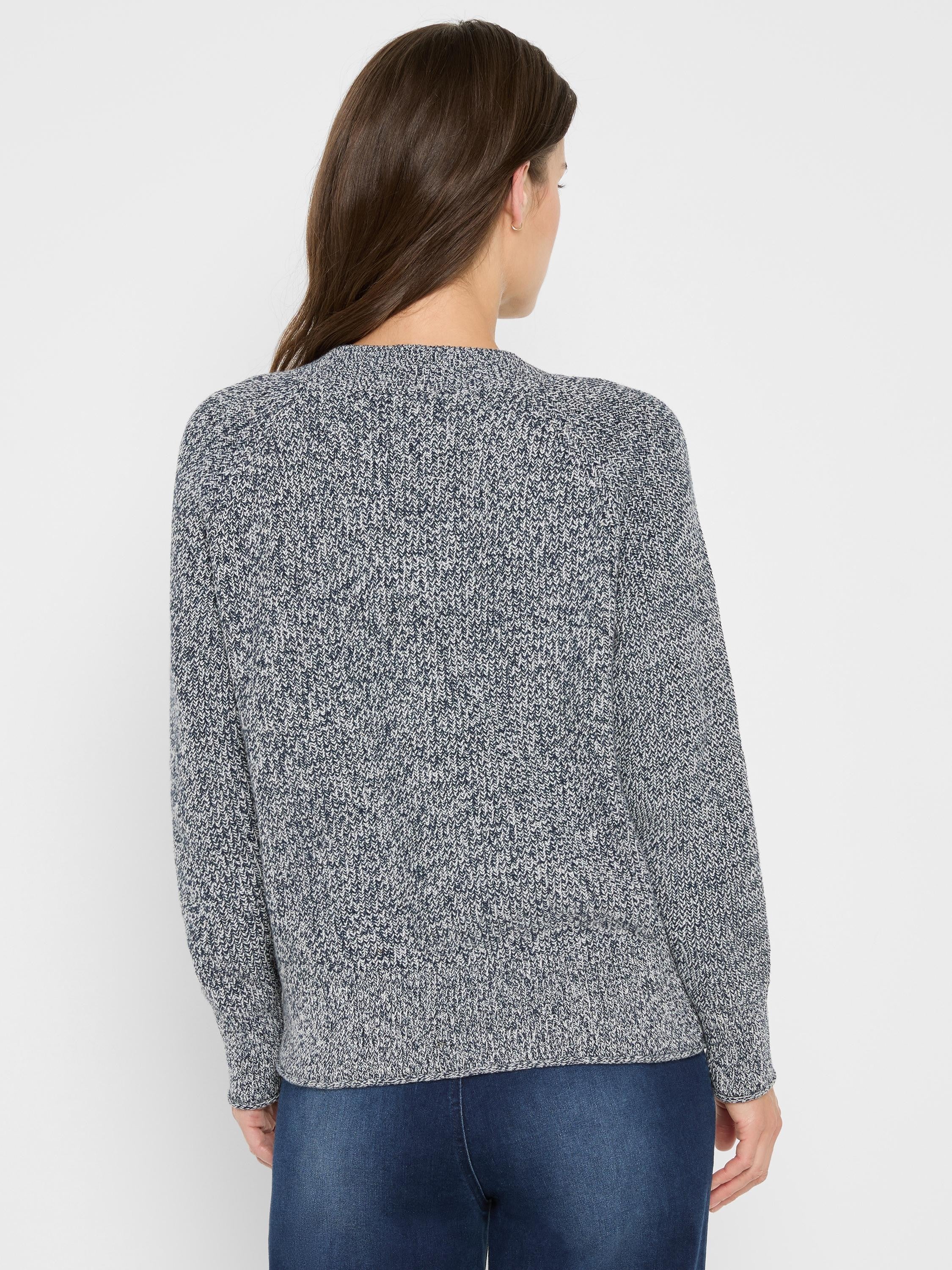 Back view of a shaker stitch sweater, made from speckled navy and white yarn, showcasing its chunky knit.
