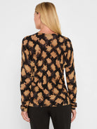 Long-sleeved tan sweater with an abstract brushstroke check pattern in dark brown and grey.