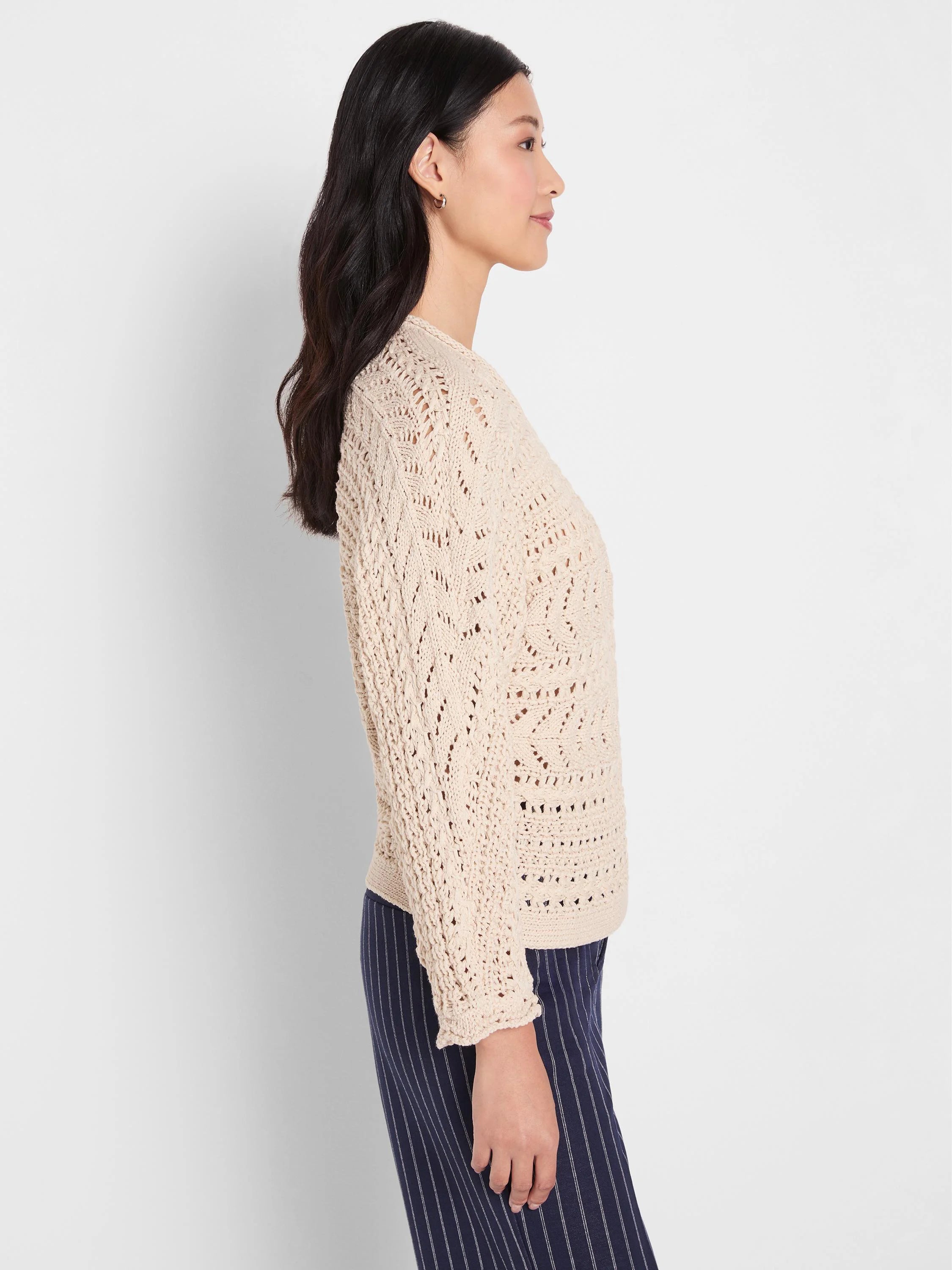 Light beige tape yarn stitch sweater featuring an open, chevron-patterned knit texture.