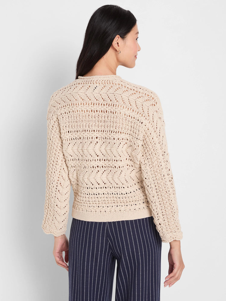 A light beige tape yarn sweater with intricate open-stitch patterns, seen from the back on a model.