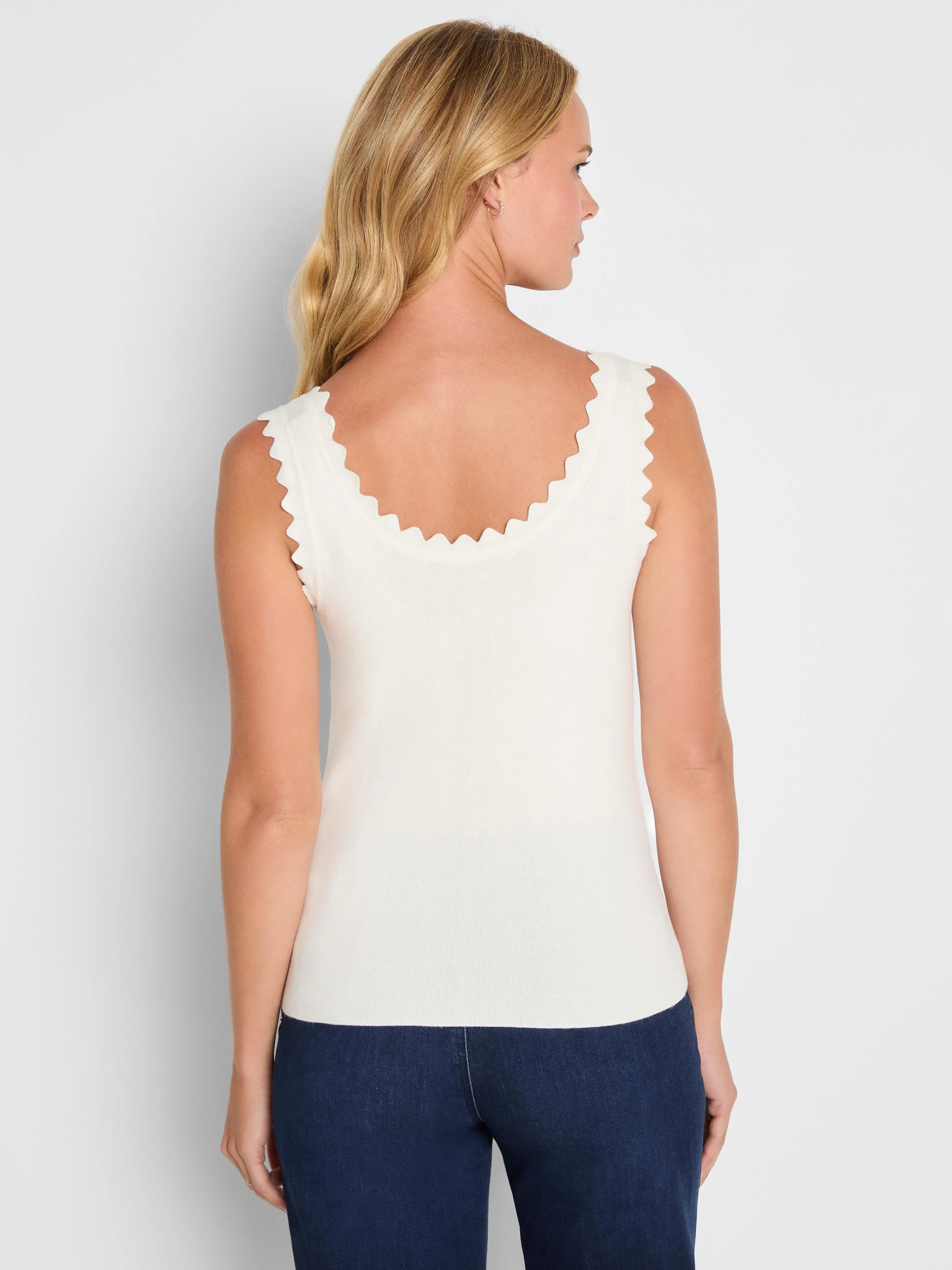 Cream ribbed tank with scalloped neckline & armholes. Model from back.