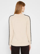 Metallic beige sweater with black braided stripes on raglan sleeves and shoulders. Crew neck, ribbed cuffs and hem.