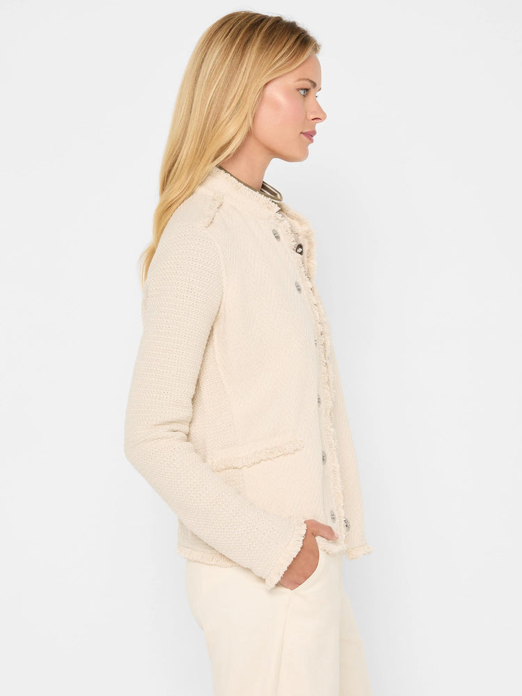 Ecru textured knit jacket with fringe trim on edges, two flap pockets, and silver-toned buttons.