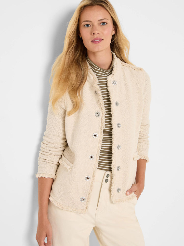 Off-white textured knit jacket with silver-tone buttons and fringe trim along the collarless neckline, placket, and cuffs.