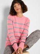 Pink knit crew neck sweater with gray horizontal stripes. Ribbed cuffs and hem, with a subtle dark gray stripe on the cuffs.