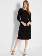 Black long-sleeve dress with a ribbed knit top and a knee-length skirt featuring horizontal fuzzy textured bands.