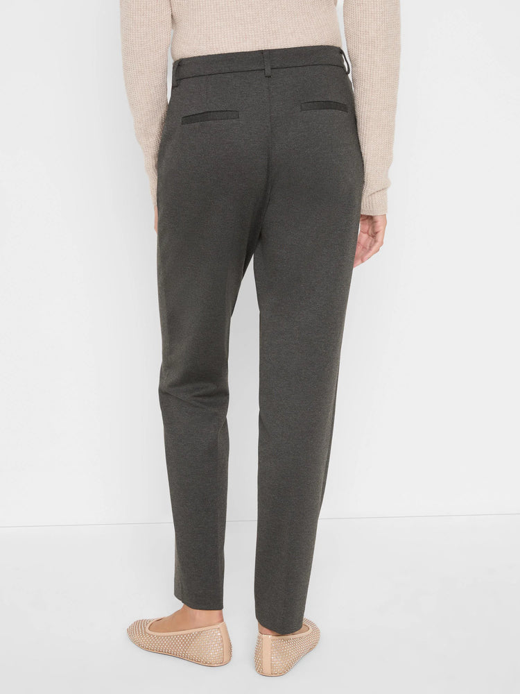Dark gray ponte knit trousers on a model, seen from behind. Features two back welt pockets and a straight, ankle-length fit.