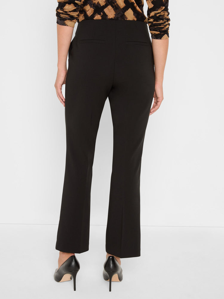 High-waisted black cropped pants have a tailored slim fit with a slight bootcut and rear welt pockets.