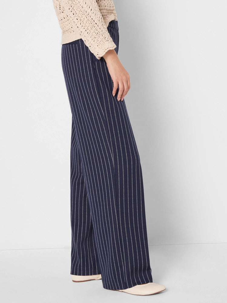 Navy wide-leg knit pants with thin white pinstripes.