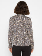 Leopard print top: cream, tan, dark brown spots. Long sleeves, high neck, smocked cuffs.