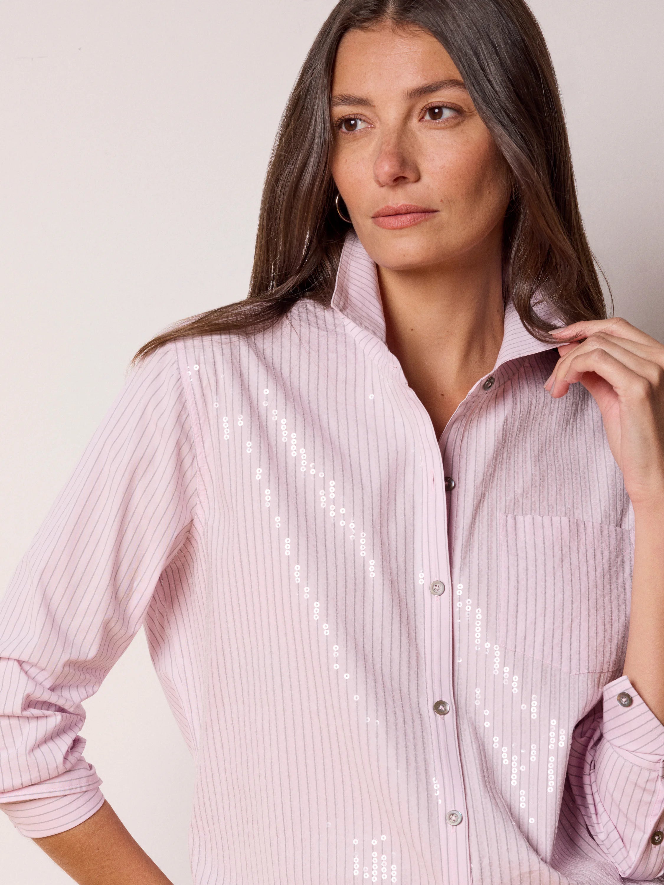 Light pink collared shirt with thin gray stripes, scattered silver sequins, and a button-down front.