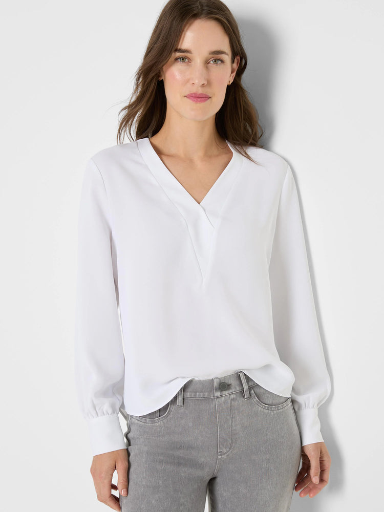 White V-neck top with overlapping front, long sleeves, and gathered cuffs.
