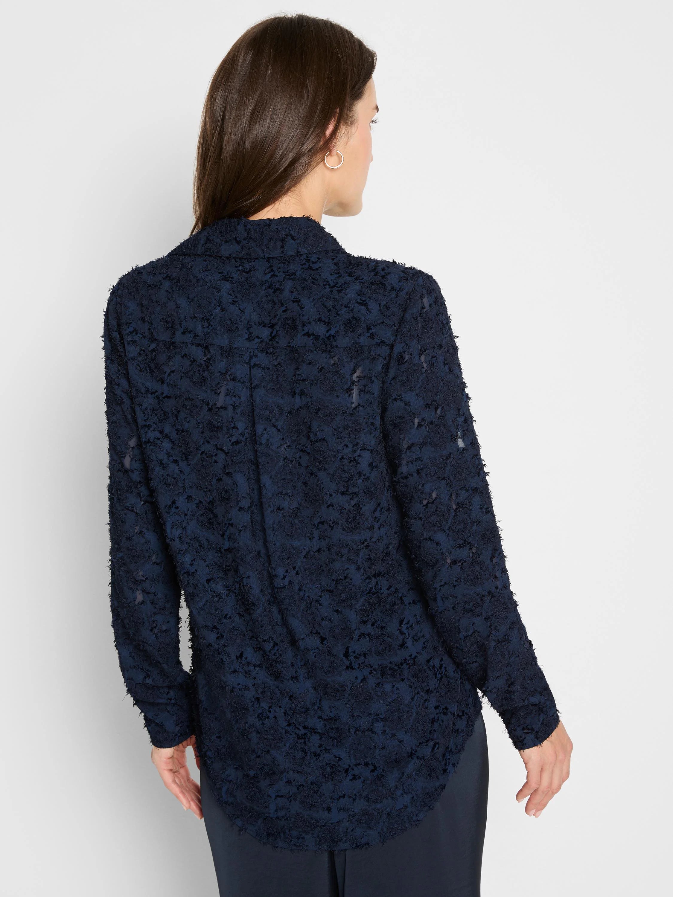 Navy blue long-sleeved top with a textured, raised clipped jacquard pattern throughout.