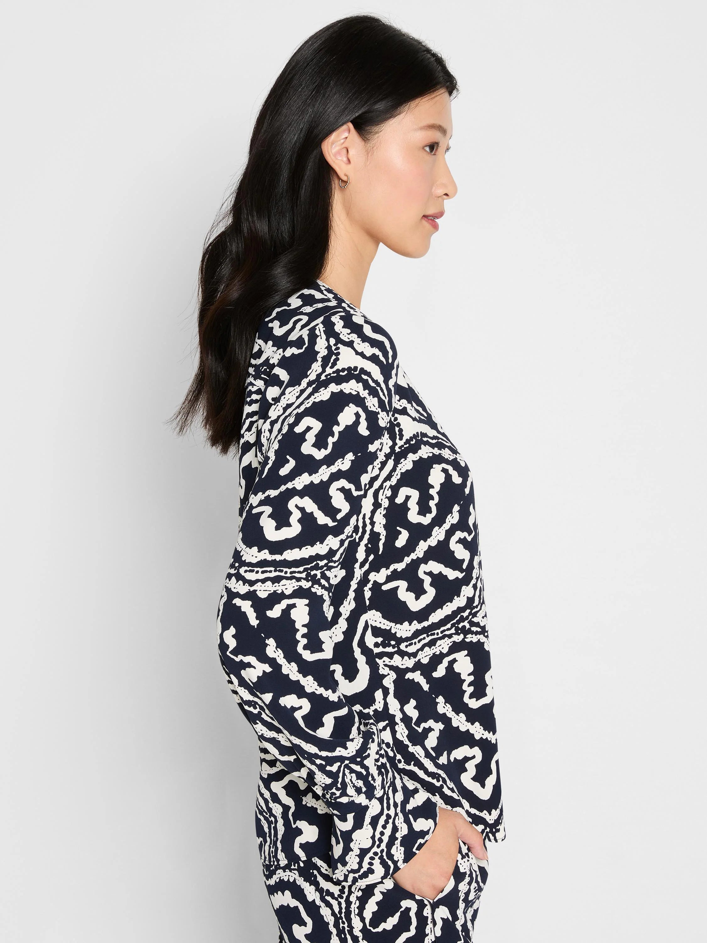 Indigo top with off-white abstract swirling leaf and dot pattern.