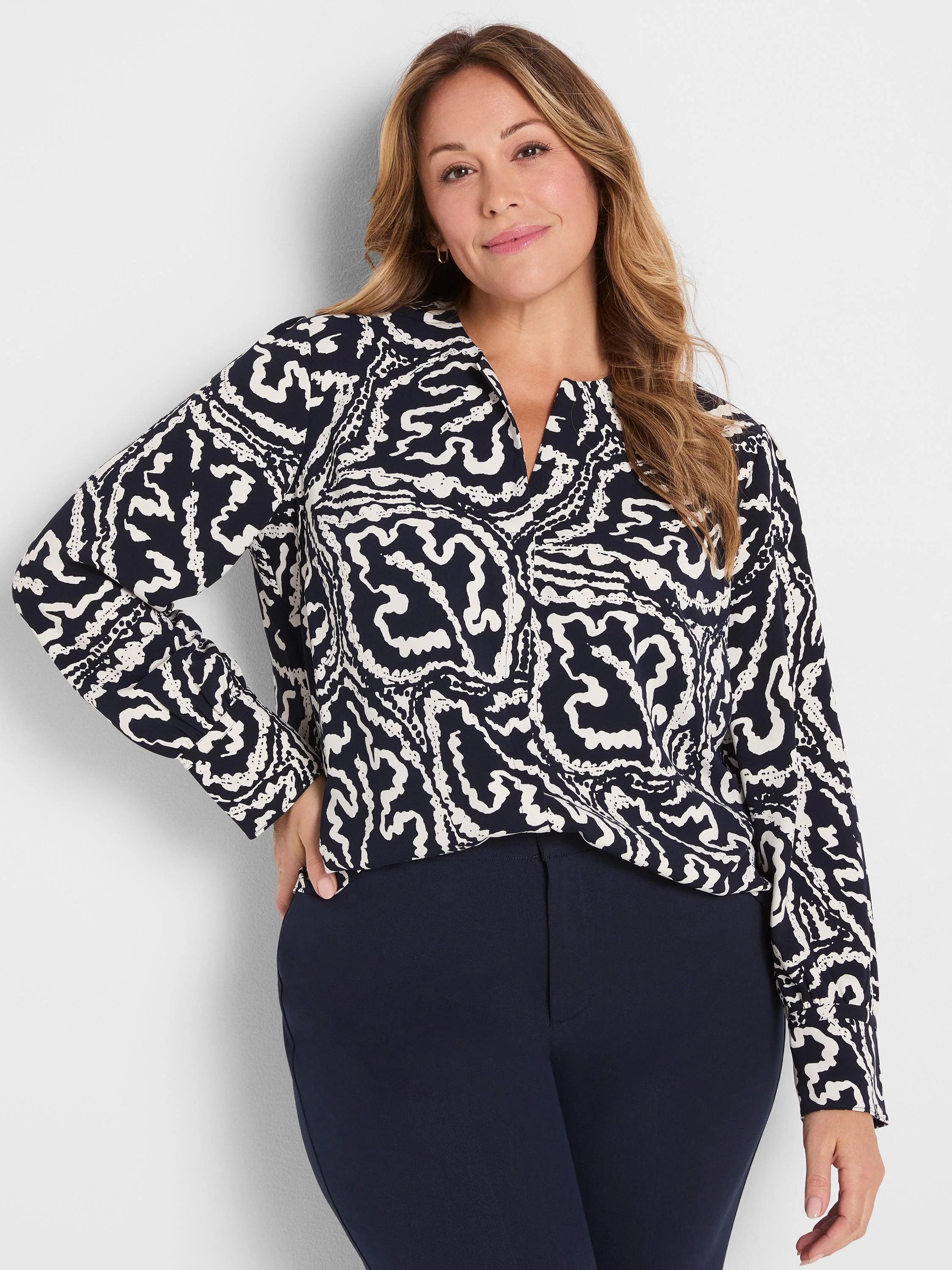 Indigo top with white abstract leaf pattern, featuring a V-neck and long sleeves.