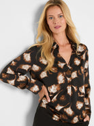 Black popover shirt featuring brown, tan, & cream ginkgo leaf pattern, V-neck, long sleeves.