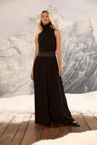 Black palazzo pants with a ruched faux leather waistband, shown on a model with a black sleeveless turtleneck.