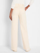 Cream wide-leg trouser jeans, rear view. Features high waist, belt loops, and horizontal back welt pockets.