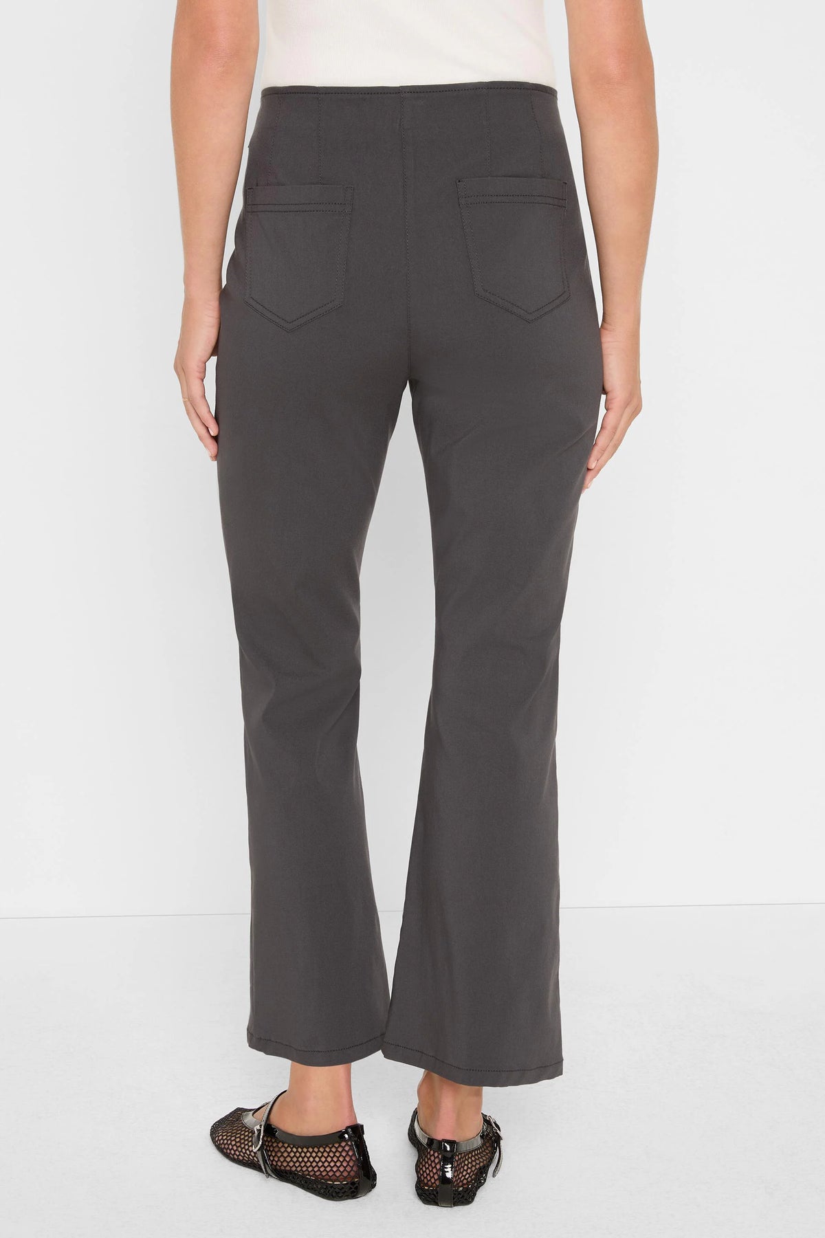 Charcoal bootcut pants, cropped length. Two back patch pockets with visible stitching.