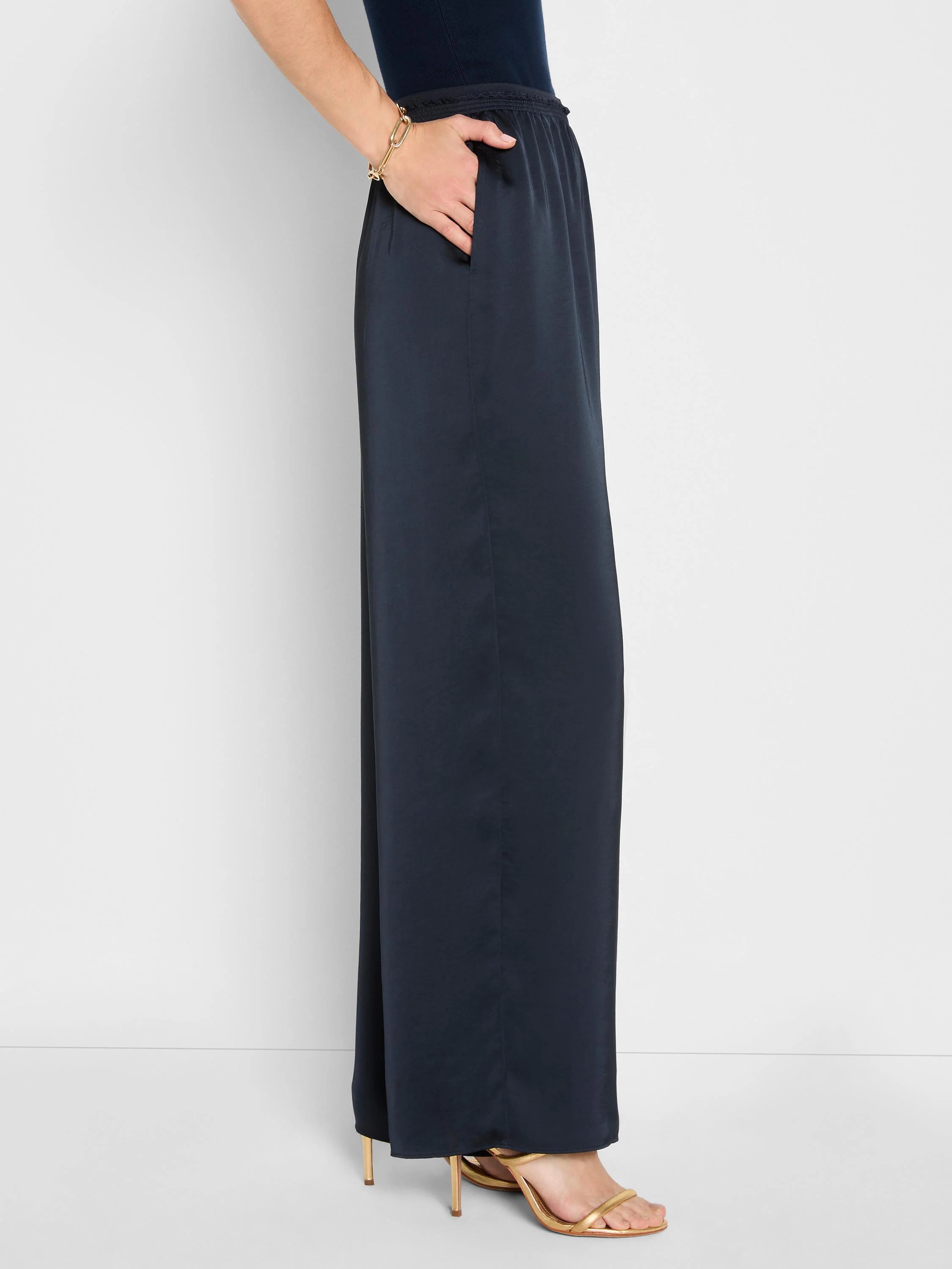 Dark navy, glossy wide-leg pull-on pants. Features an elastic waist and side pockets.